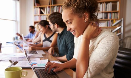 A long table filled with 5 people.